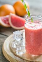 Glass jar of grapefruit smoothie photo