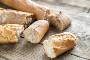 Three baguettes on the wooden background photo