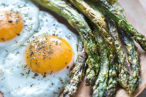 Roasted asparagus with fried eggs photo
