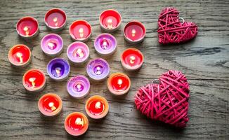 Burning candles with retro cane hearts photo