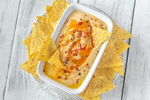 Bowl of hummus on the wooden table photo