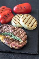 Grilled beef steak with bell peppers and cheese photo