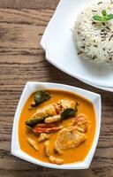 Thai panang curry with bowl of white and wild rice photo