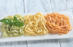 Tagliatelle with basil and tomatoes photo