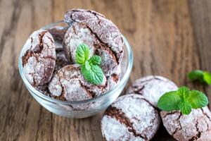 Bowl of chocolate cookies on the wooden background photo