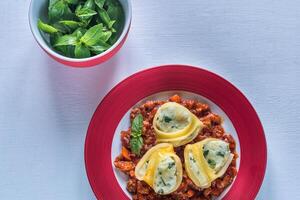 Lumaconi stuffed with ricotta with bolognese sauce photo