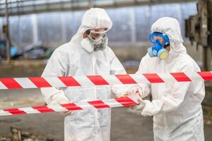 chemical specialist wear safety uniform and gas mask inspecting chemical leak in industry factory photo