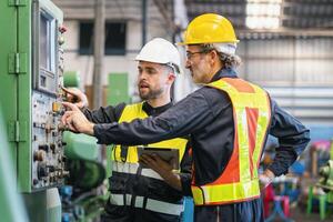 worker and engineer using tablet computer for inspection and checking production process on factory station photo