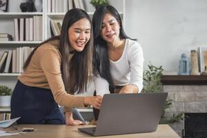 Two female accountants have a team meeting to summarize financial information in the office photo