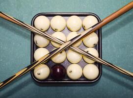 Billiards, billiard table, balls and cue. Balls in the tray and photo