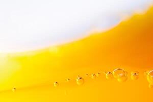 Close up bright orange juice splash texture for health and nature waves, Beautiful waves curve and little bubbles smooth for garphic design and background photo