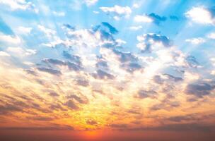 Sky, sunrise, sunset, luxury soft gradient orange gold clouds and gold sunlight between group of blue clound sky perfect for the background, take in everning,Twilight, high definition landscape photo