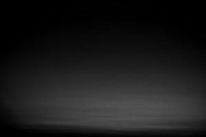 Dark black and gray blurred gradient background has a little abstract light. photo