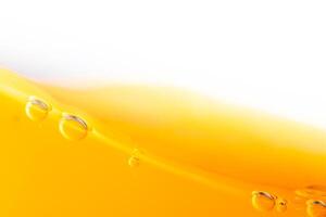 Close up bright orange juice splash texture for health and nature waves, Beautiful waves curve and little bubbles smooth for garphic design and background photo