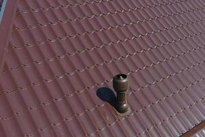 Air ducts on metal roof. The roof of corrugated sheet. Roofing of metal profile wavy shape photo