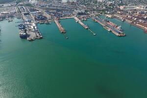 Industrial seaport, top view. Port cranes and cargo ships and barges. photo