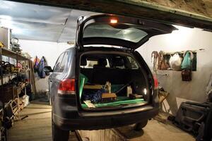 The Volkswagen car is in the garage with an open trunk. photo