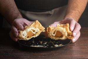 Argentinian pastelito cut in half where you can see the sweet potato candy inside. photo