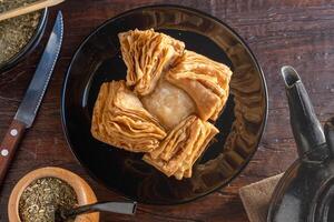 Pastelitos, an Argentine sweet that is part of traditional pastries. Made with fried dough and filled with sweet membrillo or sweet potato. photo