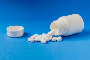 Close-up of a prescription pill bottle on a light blue background. photo