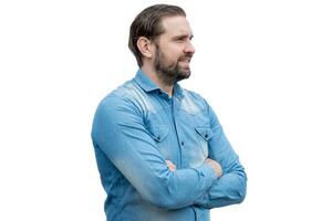 Young Caucasian Latino man wearing jean shirt and arms crossed. photo