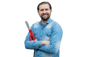 A well-dressed welder poses with his arms crossed before starting his work. photo