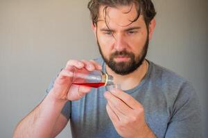 Person pouring syrup into a measuring cup. photo