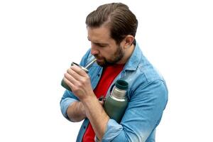 Young man drinking mate with his arms crossed. photo