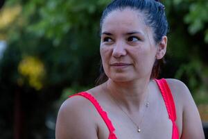 Portrait of a tanned Latin woman looking up. photo