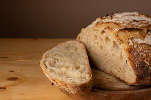 Healthy and very crunchy sourdough bread resting on a board. photo