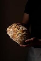 Attractive young Caucasian chef posing with white sourdough bread. photo