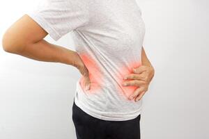 Woman suffering from waist or hip pain on white background. Chronic gastritis, office syndrome and health concept. photo