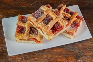 Homemade quince frola pasta in squares on wood photo