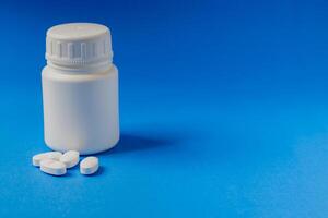 Close-up of a prescription pill bottle on a light blue background. photo