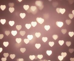 Pink blurred abstract background with cute bokeh hearts. photo