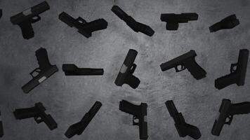 Guns. Pistols isolated on the grey wall. Guns revolve video