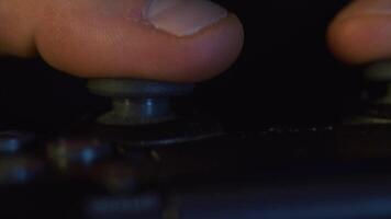 Man hands holding a gamepad close-up. Macro of man fingers is playing game console with joystick video