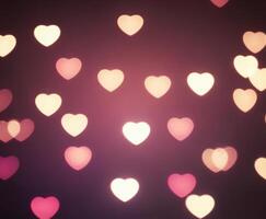 Pink blurred abstract background with cute bokeh hearts. photo