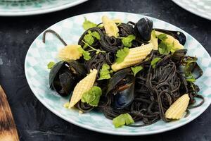 Black spaghetti pasta with mussels. photo