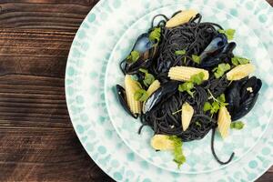 Mussels and black pasta. photo