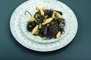 Black spaghetti pasta with mussels. photo