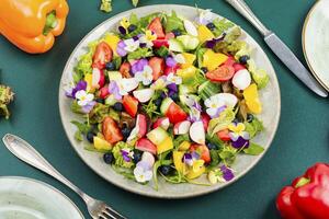 Vegetable salad decorated with flowers. photo