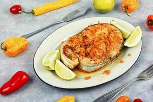 Salmon or trout steak in orange marinade. photo