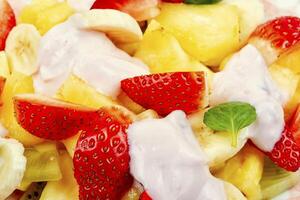 Fruit salad with yogurt on a plate. photo