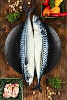Raw mackerel fish on wooden background. photo