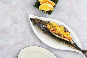 Roasted mackerel fish with oranges. photo