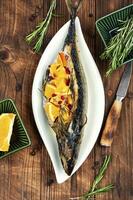 Roasted mackerel fish with oranges. photo