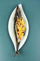 Roasted mackerel fish with oranges. photo