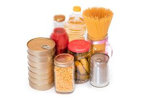 Food Reserves. Canned Food, Spaghetti, Pate, Tuna, Tomato Juice, Pasta, Fish and Grocery - Isolated on White Background. Emergency Food Storage in Case of Crisis. Strategic Food Supplies - Isolation photo