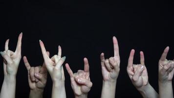 Many of hands with a goat rock sign. Isolated on a black background. video